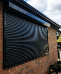 A Black Domestic Security Shutter In A Residential Garden