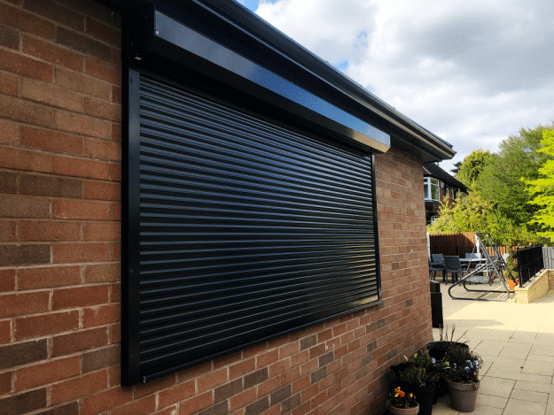 A Black Domestic Security Shutter In A Residential Garden