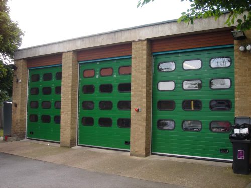 Green Sectional Door With Multiple Windows